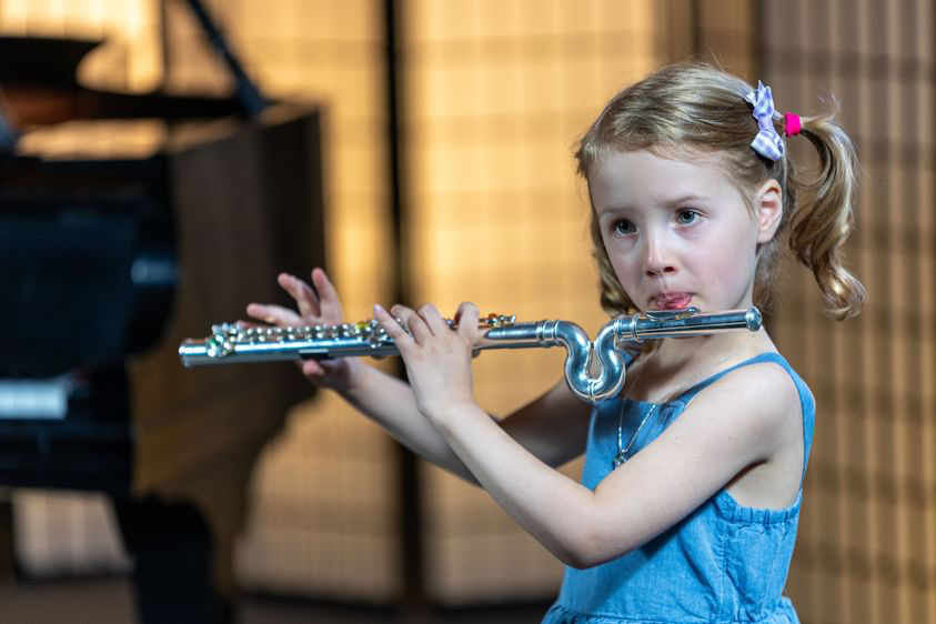 little girl playing flute